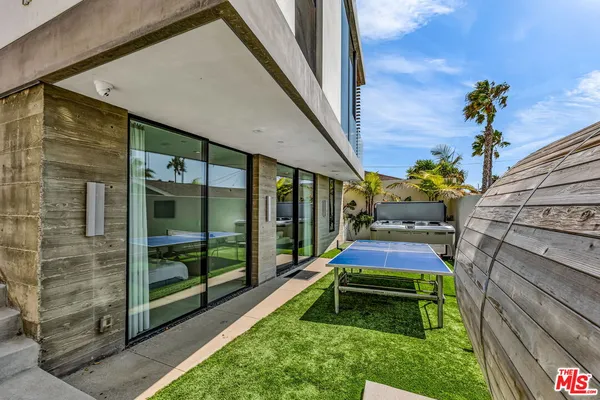 a backyard of a house with table and chairs