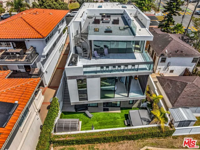 an aerial view of a house with a swimming pool
