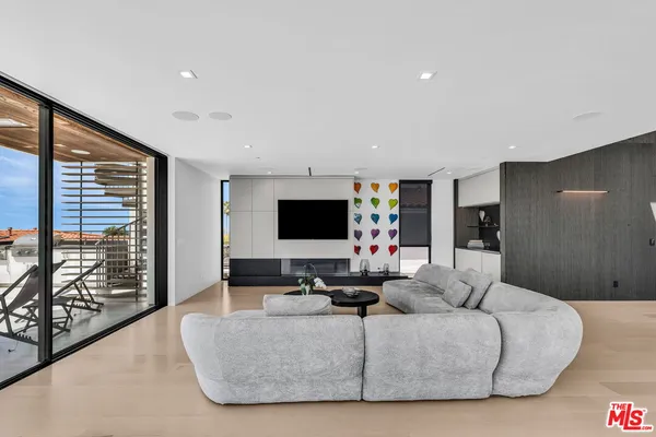 a living room with furniture floor and a flat screen tv