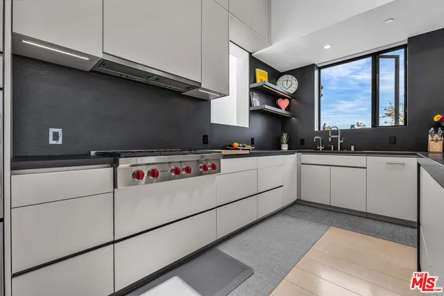 a kitchen with white cabinets sink and white appliances