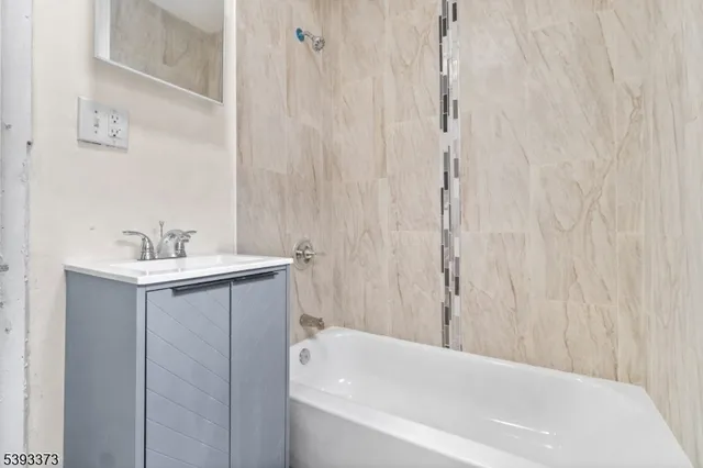 a bathroom with a bathtub a sink and a shower curtain