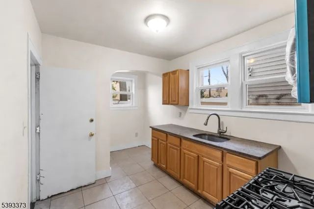 a kitchen with stainless steel appliances a sink and cabinets