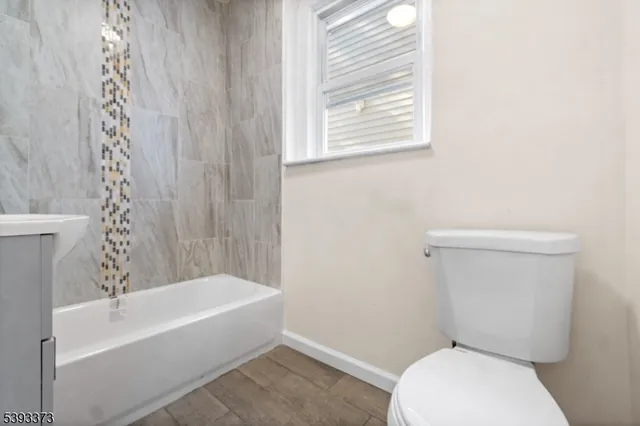 a bathroom with a toilet and a bathtub