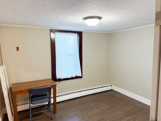 a room with a bench and wooden floor