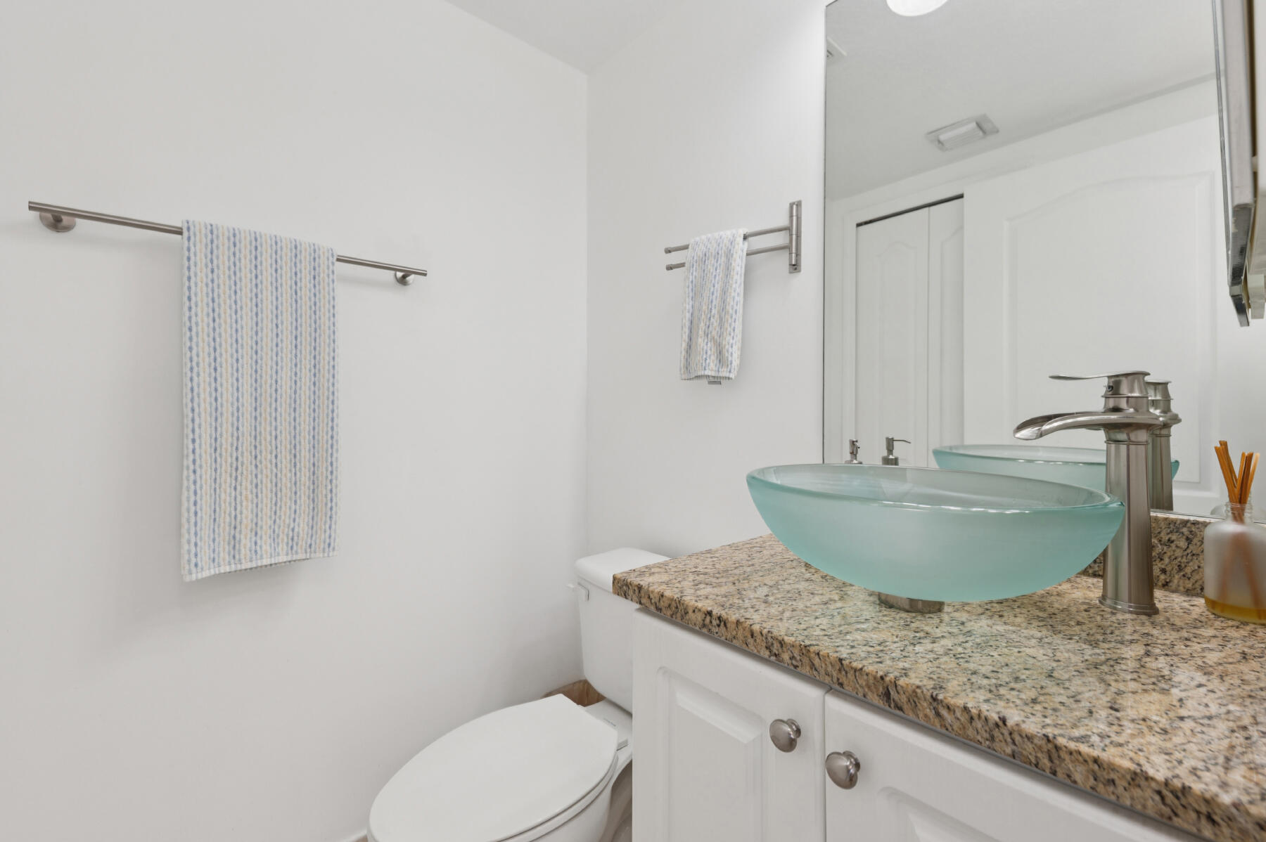 11022 Legacy Drive, Unit 101 Palm Beach Gardens, FL 33410 - Photo 12 of 16 a bathroom with a granite countertop sink and a mirror