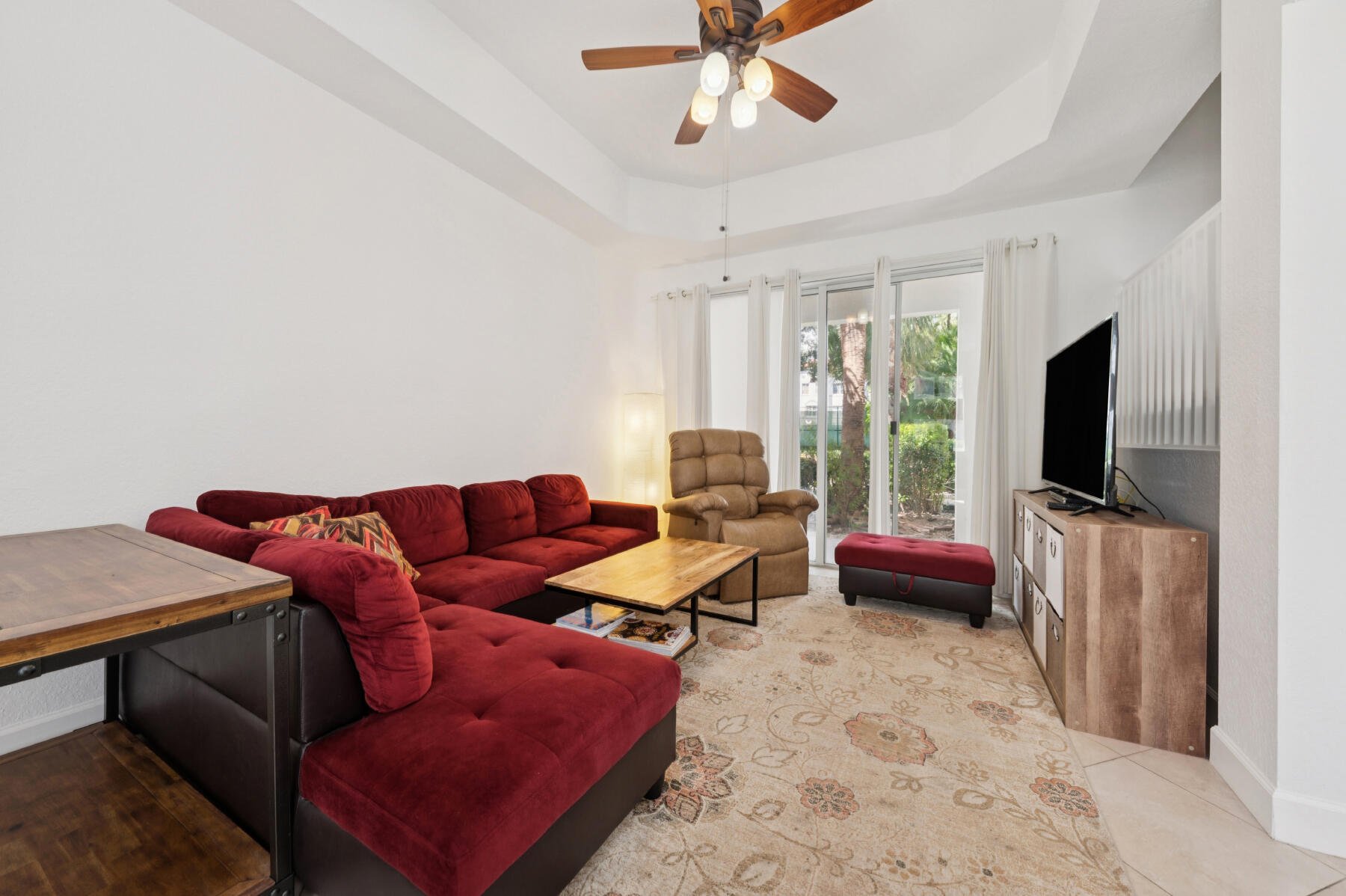11022 Legacy Drive, Unit 101 Palm Beach Gardens, FL 33410 - Photo 3 of 16 a living room with furniture and a flat screen tv