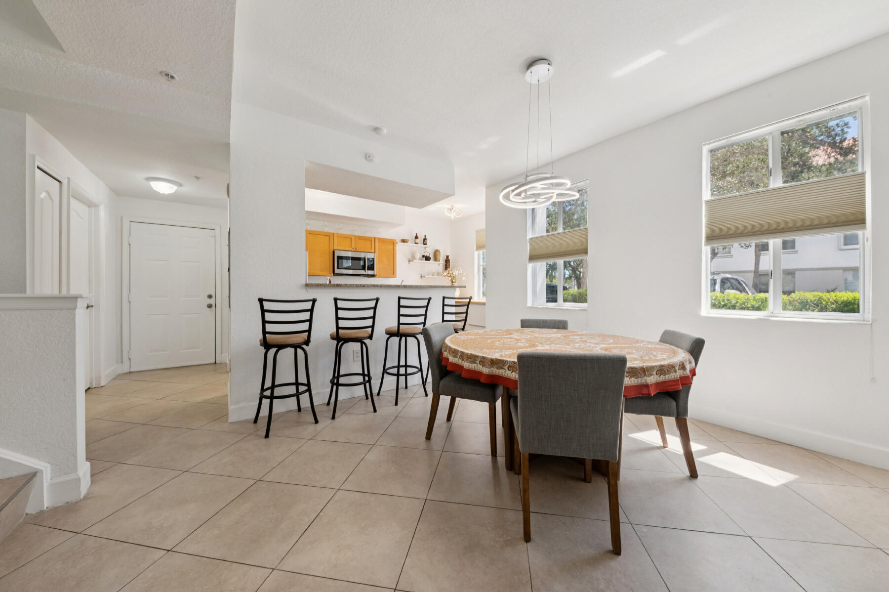11022 Legacy Drive, Unit 101 Palm Beach Gardens, FL 33410 - Photo 4 of 16 a view of a dining room with furniture