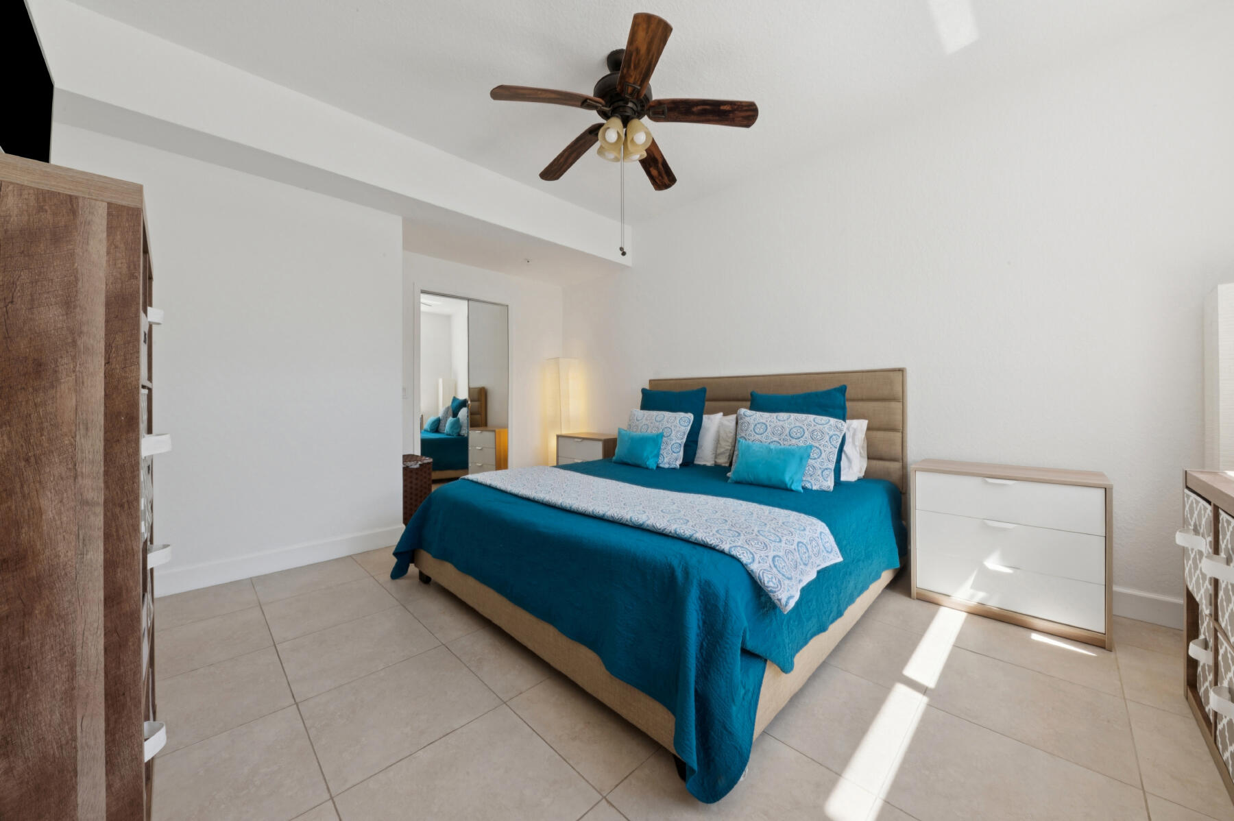 11022 Legacy Drive, Unit 101 Palm Beach Gardens, FL 33410 - Photo 7 of 16 a bedroom with a bed and a chandelier fan