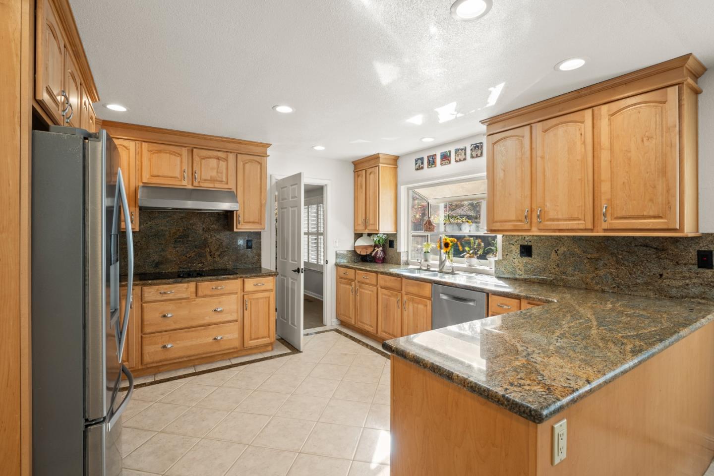26 Seminole Court San Ramon, CA 94583 - Photo 9 of 51 a kitchen with stainless steel appliances granite countertop a refrigerator a oven and white cabinets with wooden floors
