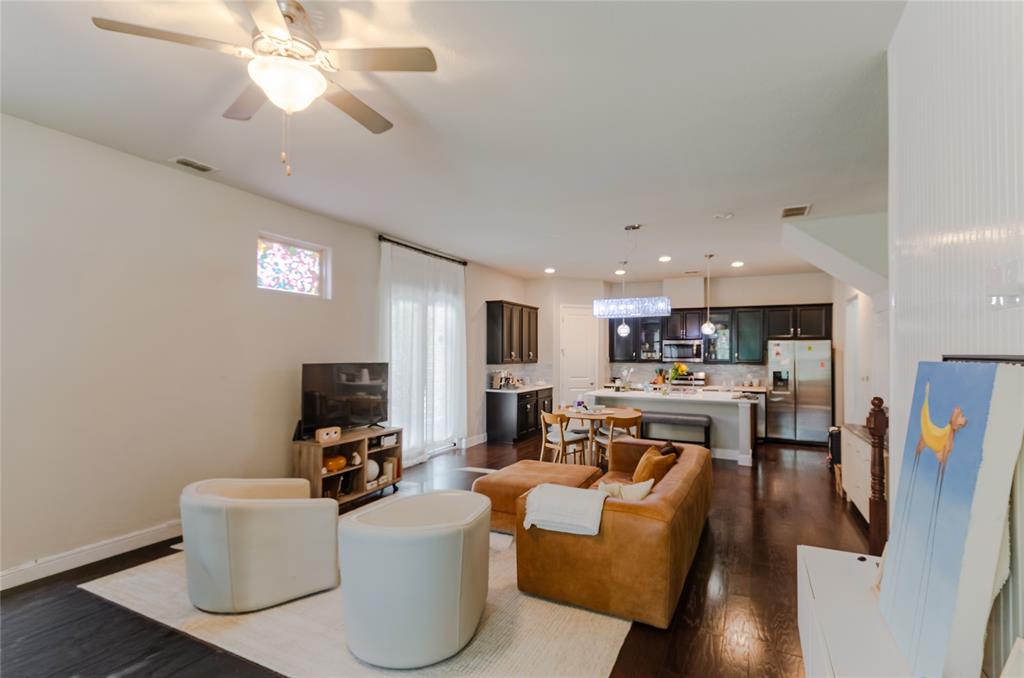 1448 Pebble Way Allen, TX 75013 - Photo 8 of 25 a living room with furniture a flat screen tv and kitchen view