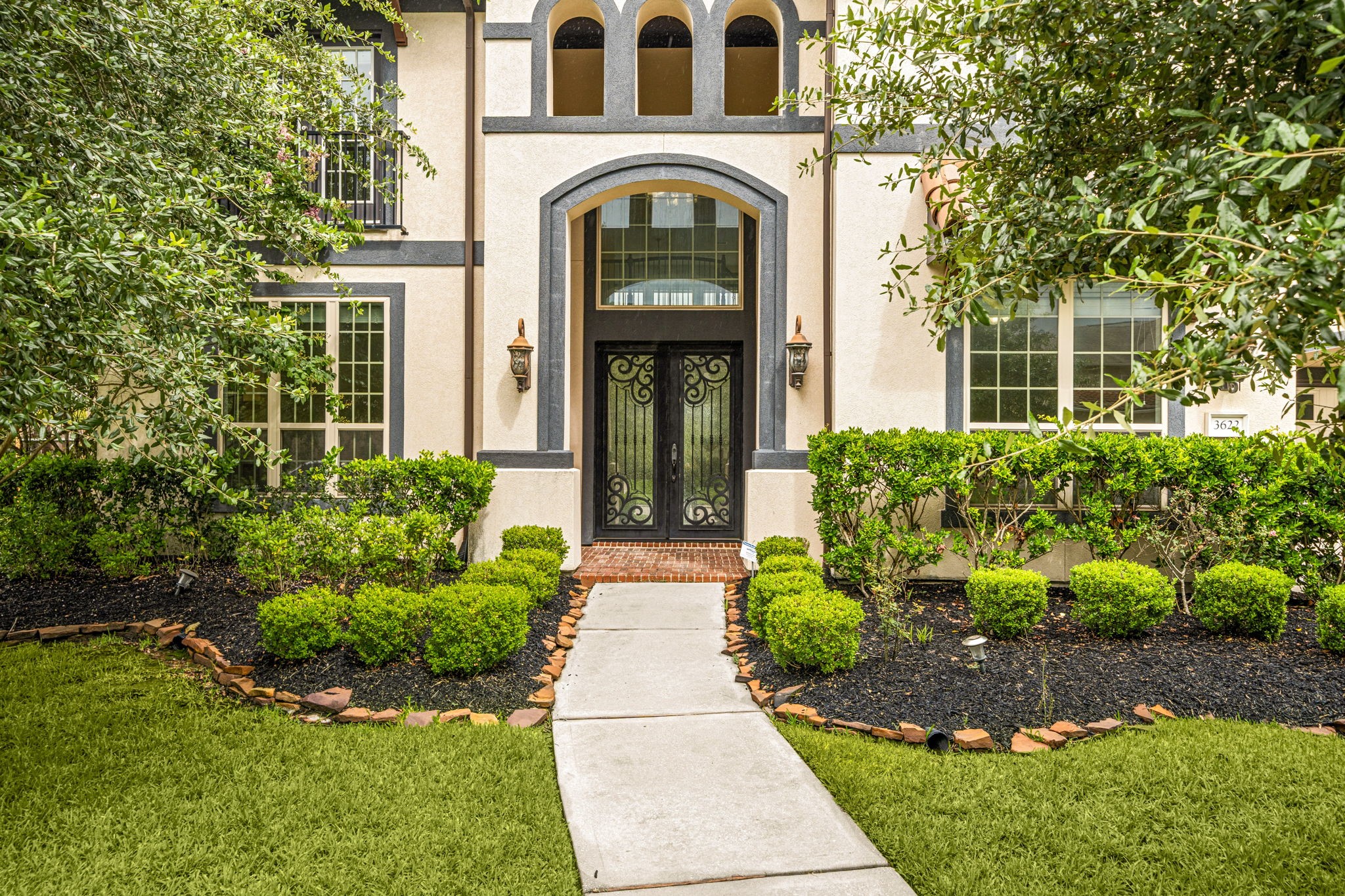 3622 Sage Hollow Drive Spring, TX 77386 - Photo 3 of 46 Make an unforgettable first impression at the main entrance, featuring a grand 8-foot Buffalo Forge Barcelona-style steel double entry door designed with rain glass panels and an antique black finish.