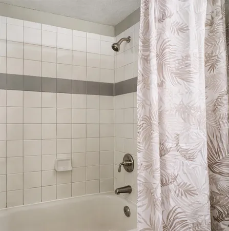 a bathroom with a bathtub and shower