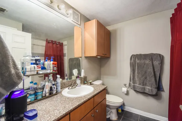 a bathroom with a sink toilet and a mirror