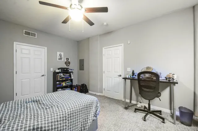 a bedroom with a bed and a chandelier