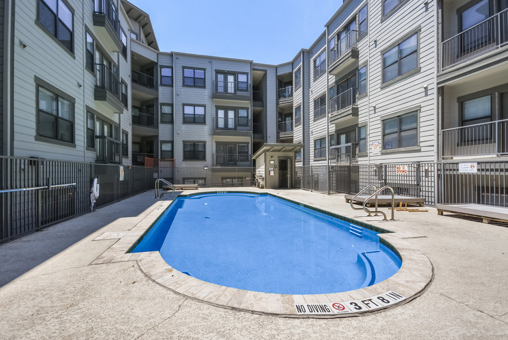 2502 Leon Street, Unit 100 Austin, TX 78705 - Photo 18 of 23 a view of a swimming pool with a lounge chairs