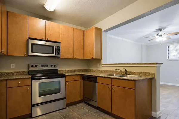 a kitchen with a sink stove and microwave