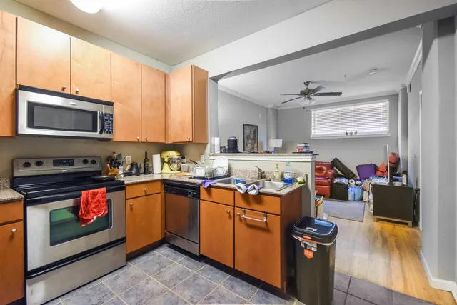 a kitchen with a stove a sink and a microwave