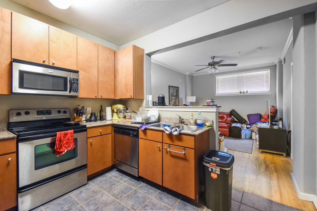 2502 Leon Street, Unit 100 Austin, TX 78705 - Photo 6 of 17 a kitchen with a stove a sink and a microwave