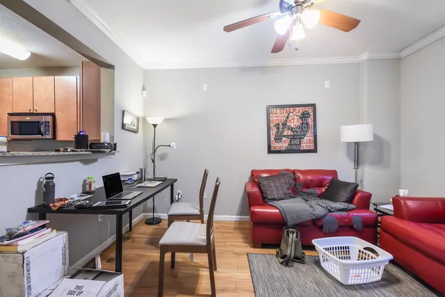 a living room with furniture and a wooden floor