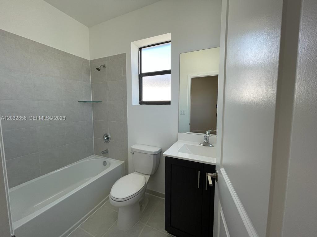 10144 Southwest 228th Terrace Miami, FL 33190 - Photo 12 of 23 a bathroom with a sink toilet and shower