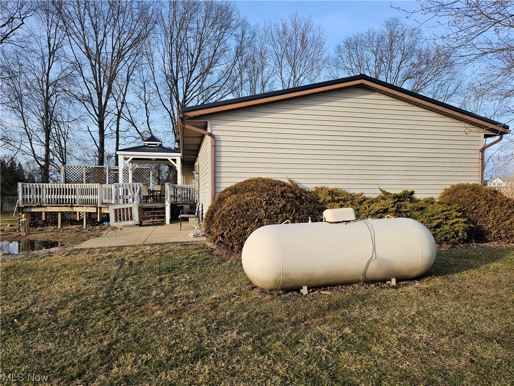 4873 Industry Road Ravenna, OH 44266 - Photo 24 of 27 South/Left Side of Home; View of Back Deck Off Rear with Area Ready for a Pool