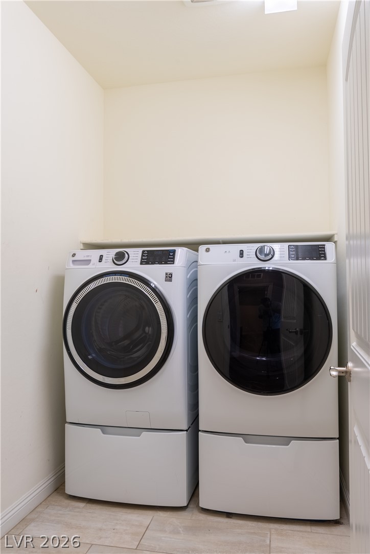 11045 Elk Sands Road Las Vegas, NV 89179 - Photo 24 of 67 Tiled flooring and neutral walls define this dedicated laundry alcove.
