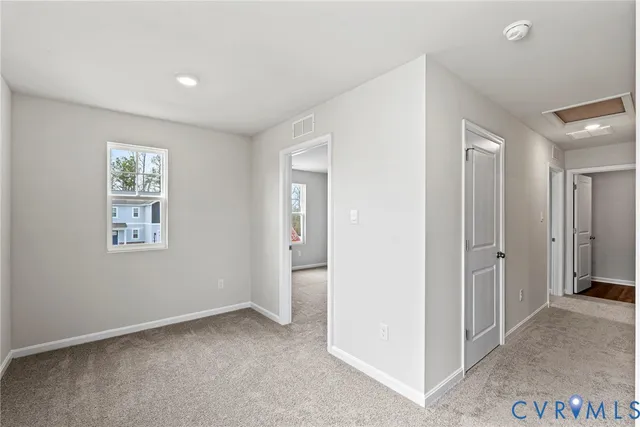 an empty room with windows and closet