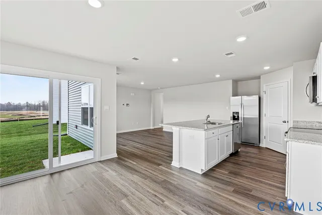 a kitchen with stove and wooden cabinets