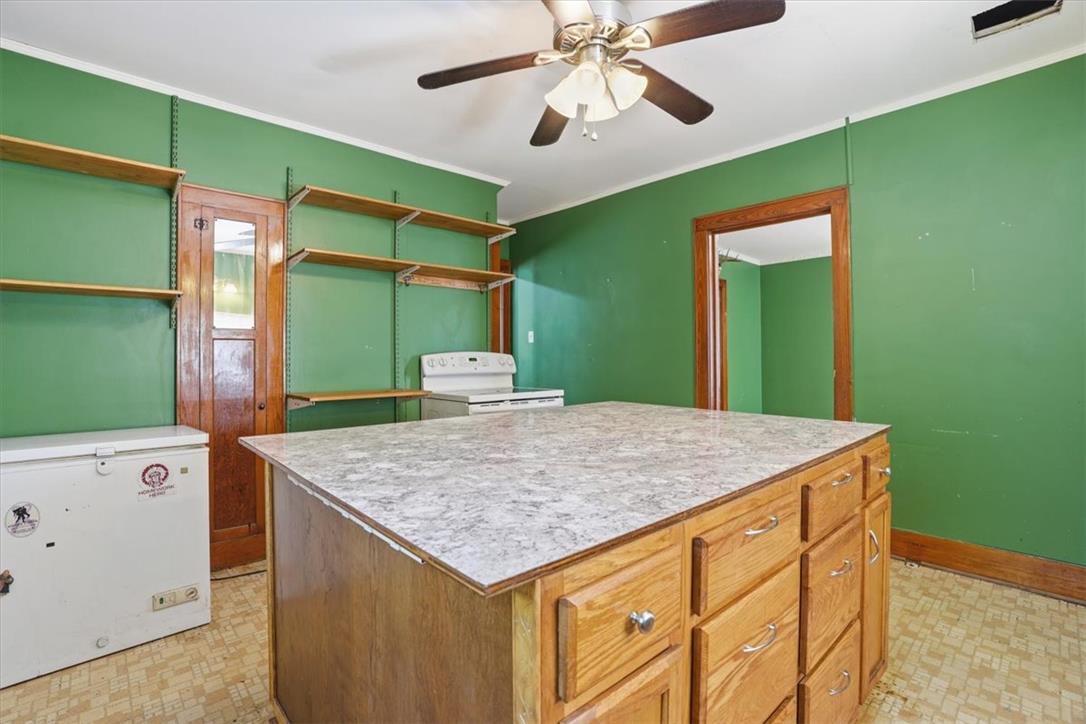 167 Main Road Lehighton, PA 18235 - Photo 15 of 41 A utilitarian kitchen layout with open shelving and a central island workspace.