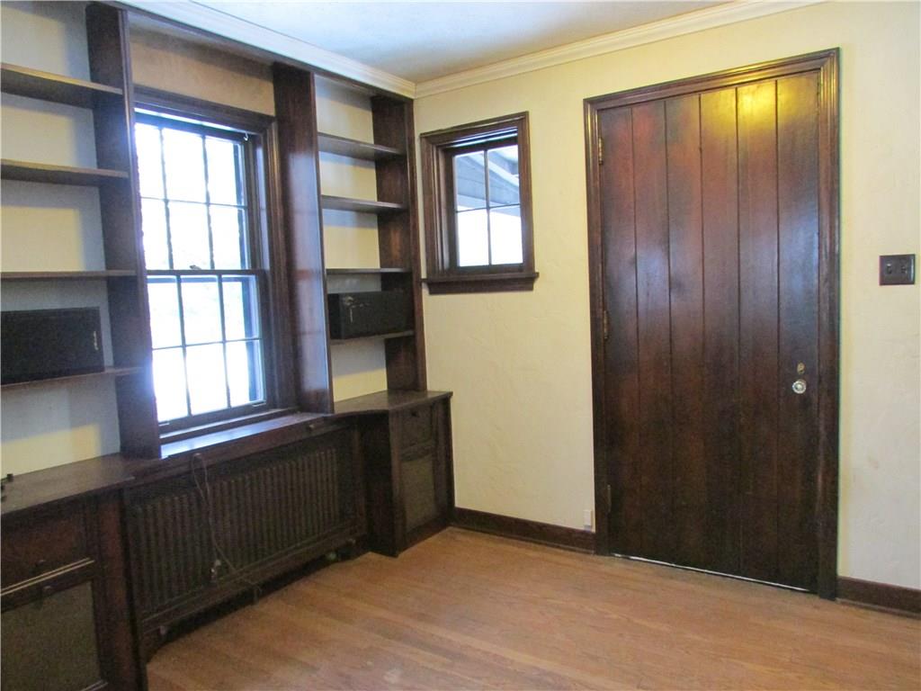 Entry/Living room has built in bookshelves and original entry door.