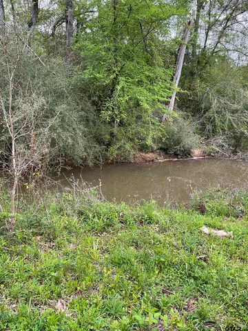 a view of a lake with a yard