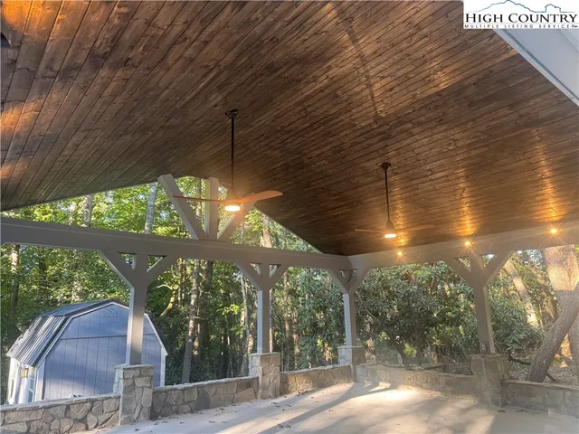 a view of a house with backyard and trees