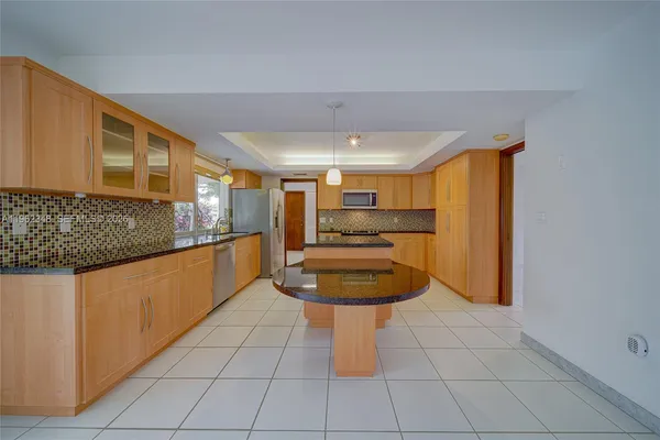 a kitchen with stainless steel appliances granite countertop a sink and cabinets