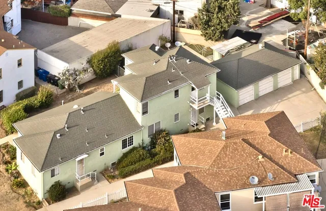 an aerial view of a house with yard