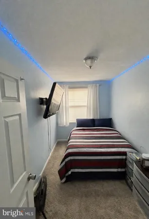 a bedroom with bed and a window