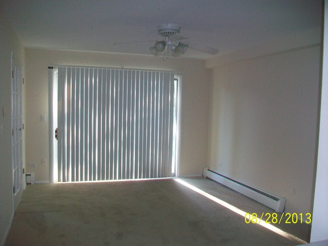 904 Ridge Square, Unit 110 Elk Grove Village, IL 60007 - Photo 2 of 10 a view of an empty room with a window