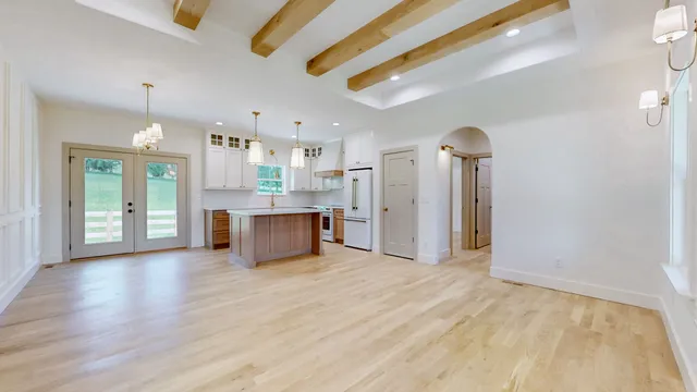 a view of a kitchen with a refrigerator and a sink