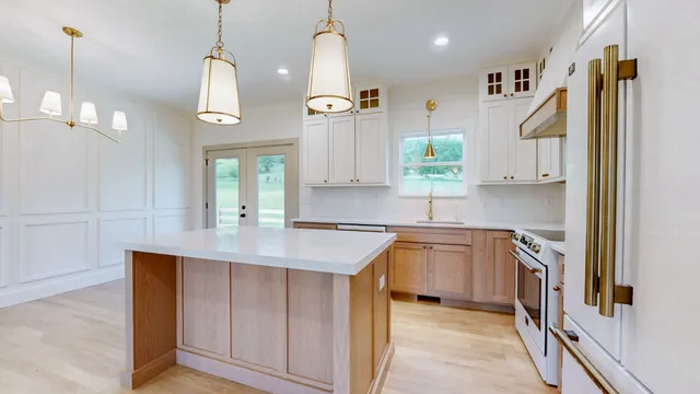 a kitchen with a sink stove and refrigerator