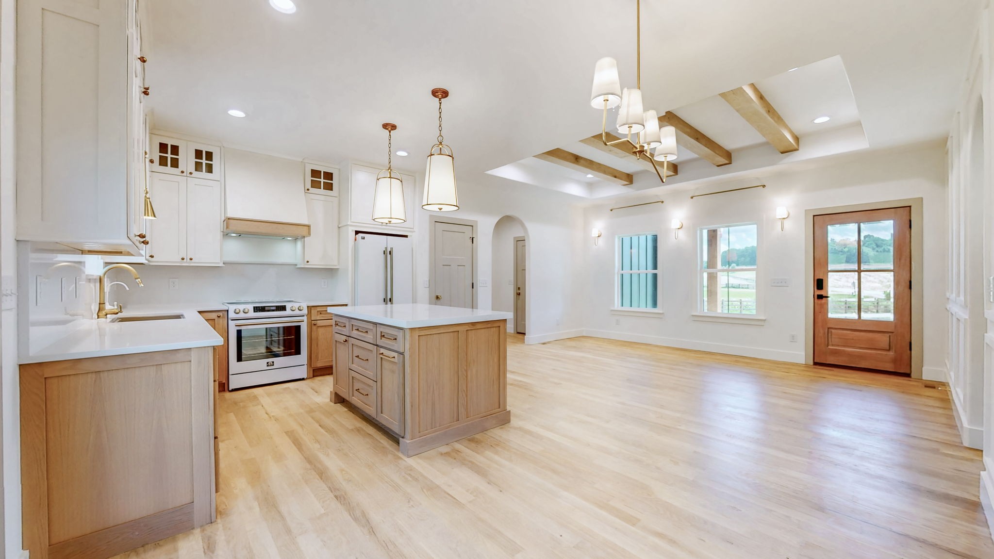 9718 Campbellsville Road Pulaski, TN 38478 - Photo 8 of 21 a large kitchen with stainless steel appliances kitchen island granite countertop a stove a sink a refrigerator and a dining table with wooden floor