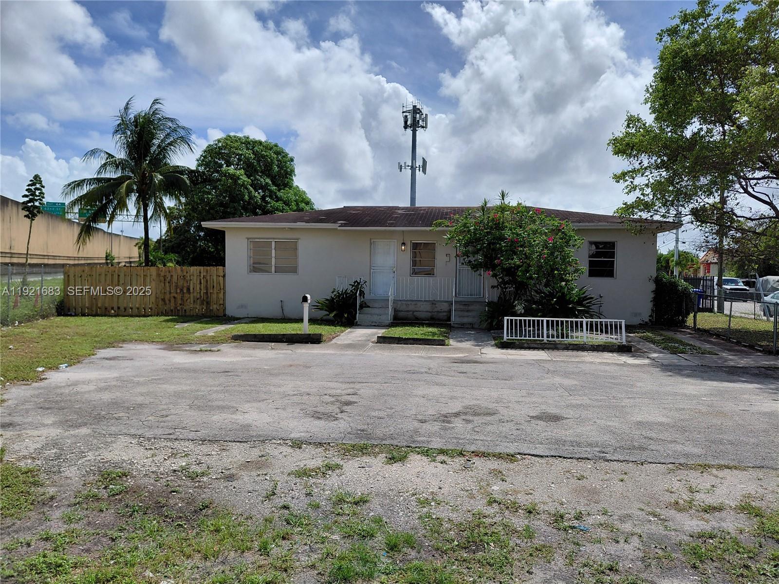 a front view of a house with a yard and a garage