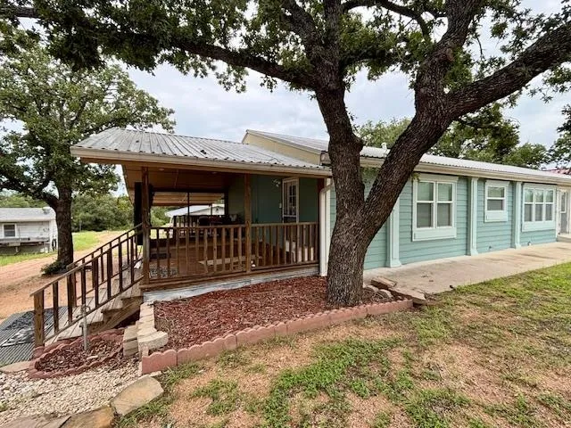 a front view of house with yard outdoor seating and barbeque oven