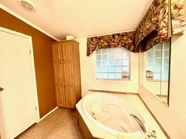 a bathroom with a tub and a window