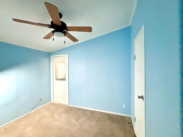a view of a hallway with a ceiling fan