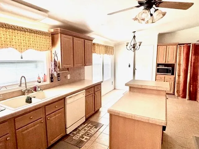 a kitchen with a sink and a refrigerator