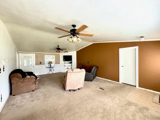 a bedroom with a bed and ceiling fan