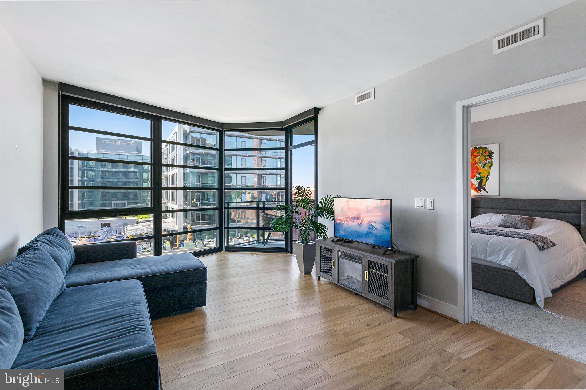 1300 4th Street Southeast, Unit 711 Washington, DC 20003 - Photo 1 of 28 a living room with furniture and a flat screen tv
