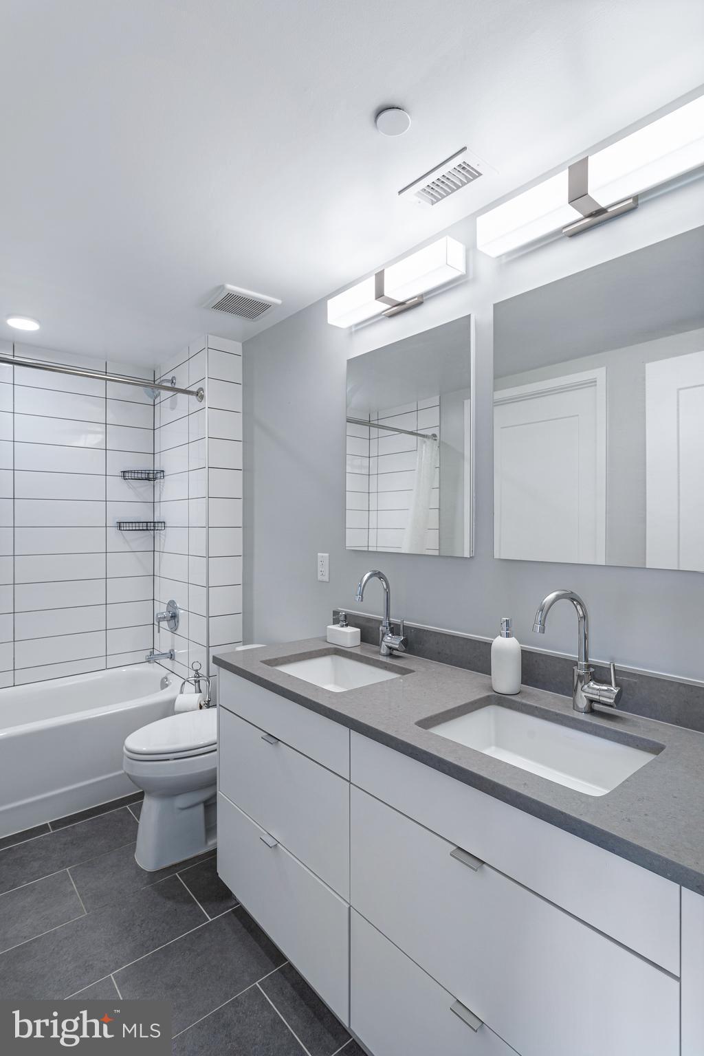 1300 4th Street Southeast, Unit 711 Washington, DC 20003 - Photo 16 of 28 a bathroom with a double vanity sink and a mirror