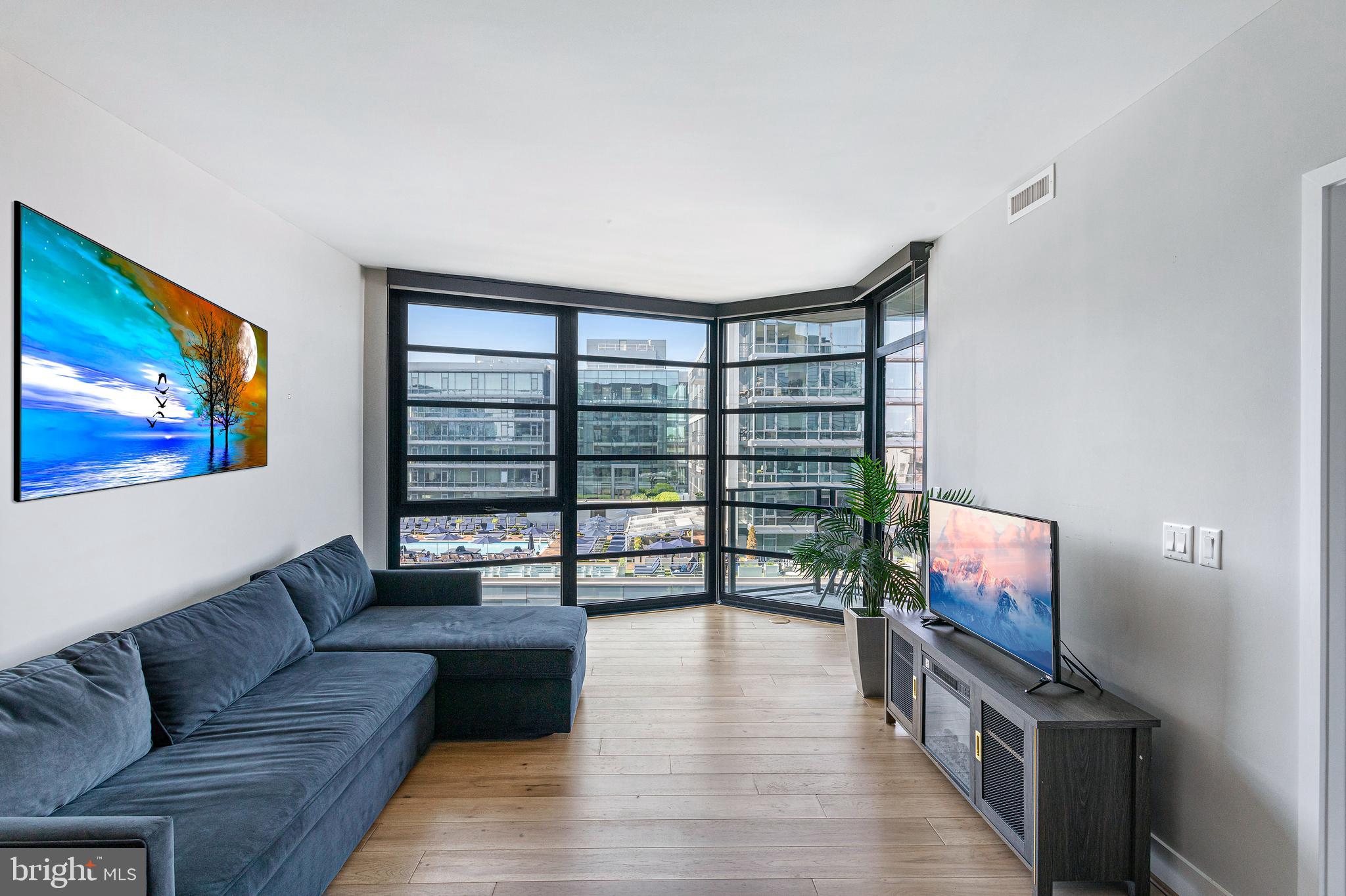 1300 4th Street Southeast, Unit 711 Washington, DC 20003 - Photo 2 of 28 a living room with furniture and a flat screen tv