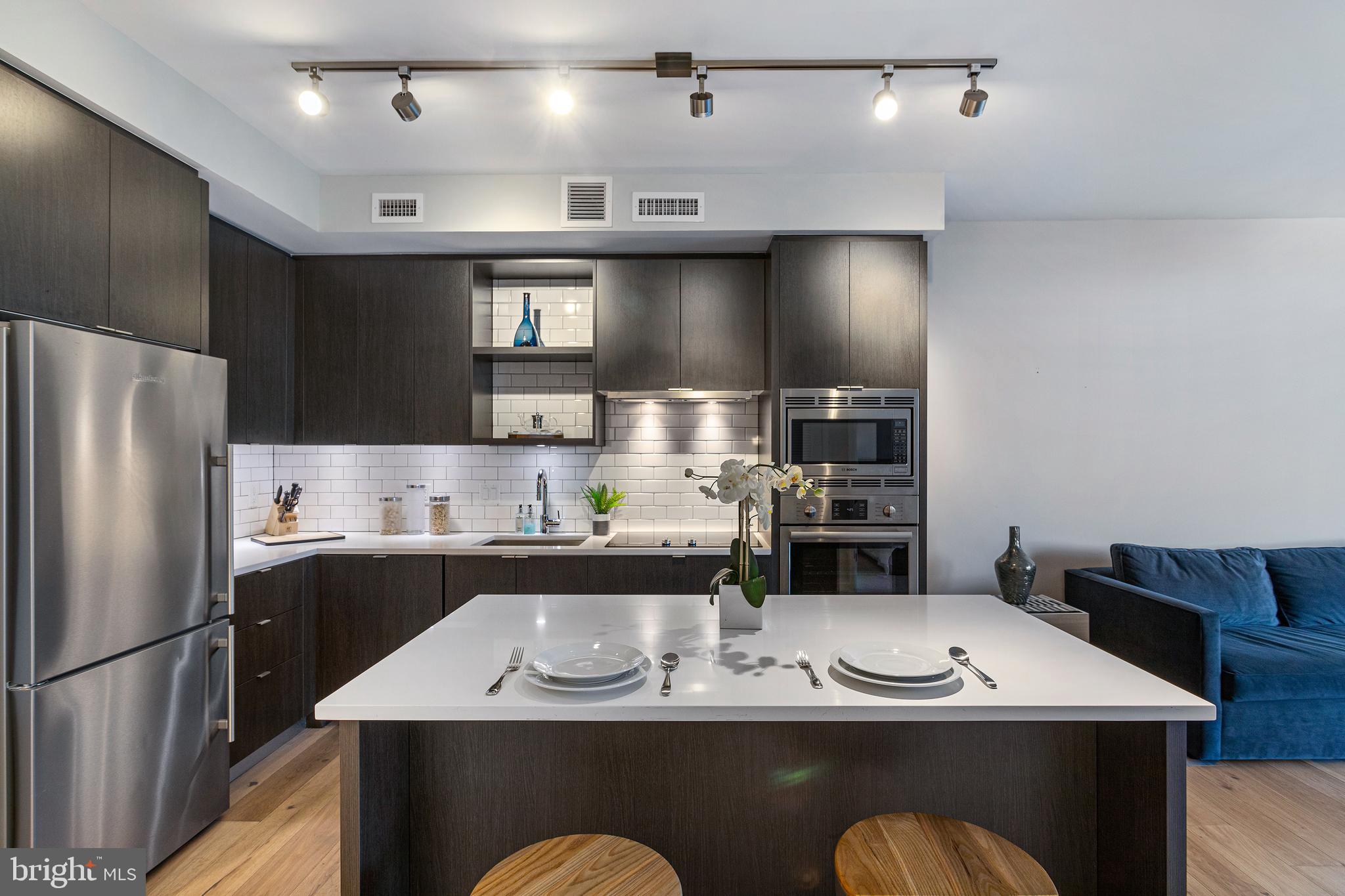 1300 4th Street Southeast, Unit 711 Washington, DC 20003 - Photo 9 of 28 a kitchen with stainless steel appliances granite countertop a sink a stove a refrigerator and a refrigerator