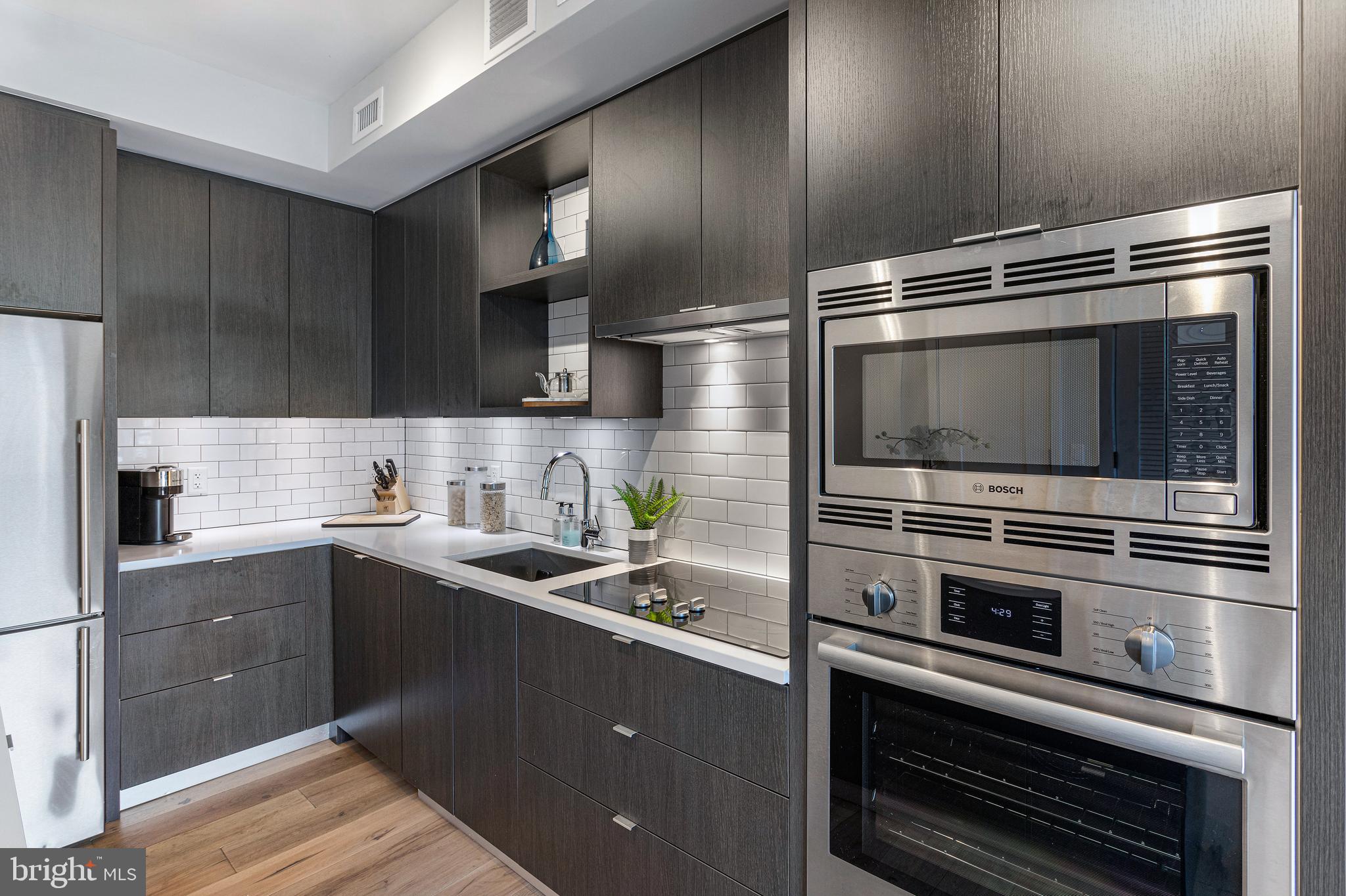 1300 4th Street Southeast, Unit 711 Washington, DC 20003 - Photo 10 of 28 a kitchen with a sink and stainless steel appliances